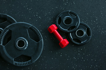 Sticker - Weight plates and dumbbell on floor in gym