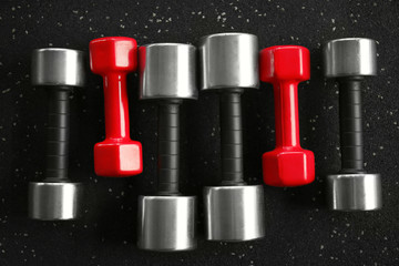 Canvas Print - Different dumbbells on floor in gym