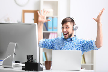 Handsome young programmer working in office