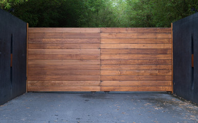 Sliding driveway door with iron and wooden panel