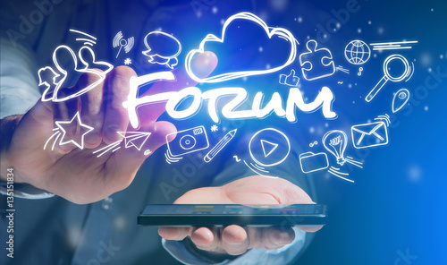 Photo  Concept of man holding smartphone with forum icon around