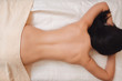 © golubovy - Nude woman back on massage table flat lay. Top view on half naked brunette with perfect body lying on her stomach at spa salon. Beauty, slim, health care, pleasure, fitness, thin waist concept