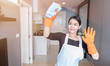 Asian young maid cleaning the mirror at home, Cleaning service concept