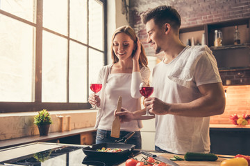 Wall Mural - Beautiful couple cooking