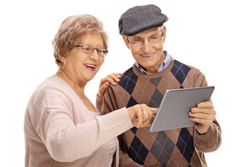 Poster - Happy seniors looking at a tablet