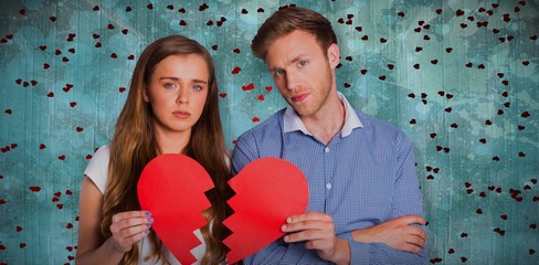 Wall Mural - Composite image of couple holding broken heart