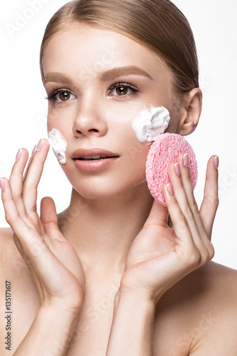 Leinwand Poster Beautiful young girl with sponge and foam cleanser and French manicure