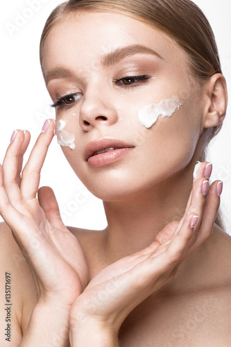 Leinwand Poster Beautiful young girl with cream on the skin and French manicure