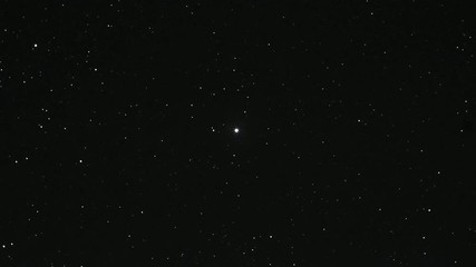 starry sky time lapse with the north pole star (alpha ursae minoris) in the center.
