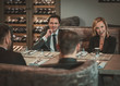 © Nejron Photo - Group of successful business people discussing during business dinner in restaurant