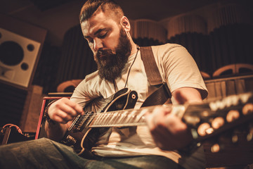 Wall Mural - Professional guitarists performing in boutique recording studio