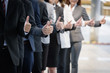 © iStocker - smart  business team standing show symbol like on hand