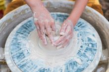 Childs Hands Spinning Clay On Pottery Wheel 