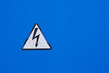 High voltage sign on blue wall