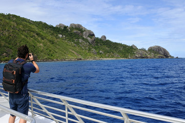 Travel photographer photographing the landscape of a tropical is