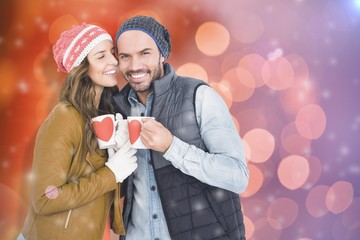 Poster - Composite image of happy young couple holding coffee mug