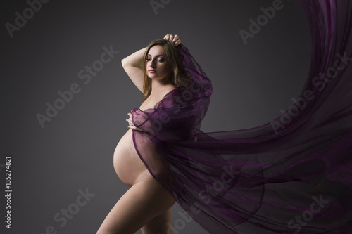 500px x 334px - Beautiful naked pregnant woman with purple silk on gray ...