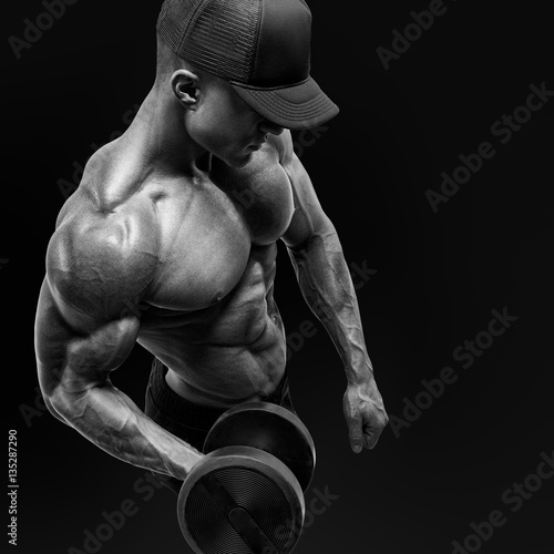 Plakat na zamówienie andsome power athletic man bodybuilder doing exercises with dumb