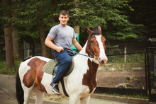 Portrait Of Happy Man Riding Horse