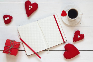 Open blank notebook, gift box with Valentine hearts and cup of c