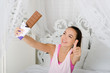 © seredalia - Young beautiful smiling woman holding a chocolate bar and looking at him. Keep the thumbs up