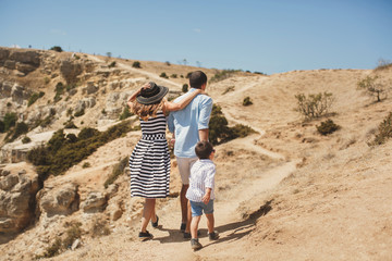 Happy family of four walking in the mountains. Family concept. F