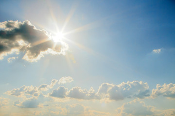 blue sky with clouds and sun.