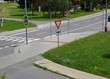 road with traffic signs, pedestrian crossing, green grass