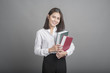 © tonefotografia - Beautiful teacher Woman holding book on grey background