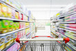 © nonnie192 - Supermarket aisle with empty red shopping cart