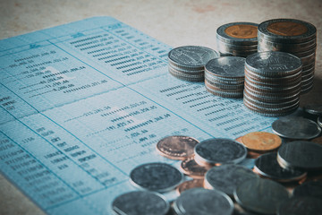 row of coins and account book on the table in banking and financ