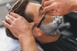Professional barber getting rid of male stubble