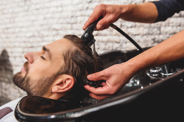 Sticker - Professional barber undergoing hairwash at salon