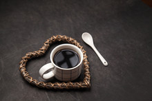 Cup Of Black Coffee For Coffee Lovers. Americano Into The Mug On Dark Background With Wooden Heart Shape, Good For Health.