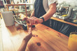 © Yakobchuk Olena - Counterman taking remuneration of visitor in cafe