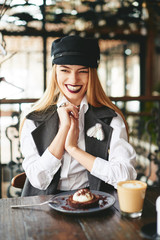 Wall Mural - Stylish fashion beautiful girl eating chocolate desert brown with white cream