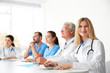 © Africa Studio - Team of doctors sitting at table in clinic