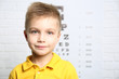 © Africa Studio - Little boy on ophthalmic test chart background