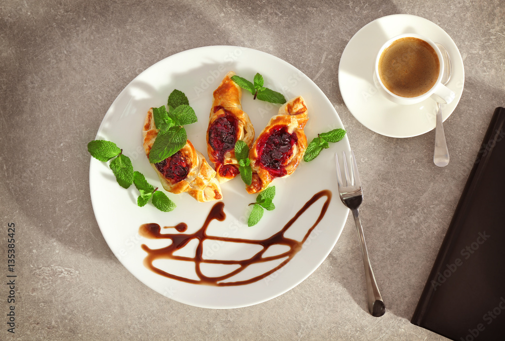 Sweet tasty pastries on plate, top view