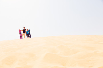Canvas Print - Tourists Sand Skiing In The Desert