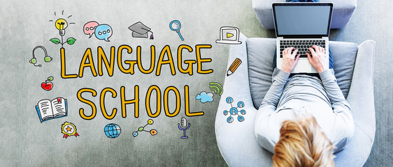 Wall Mural - language school text with man using a laptop