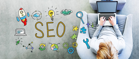 Wall Mural - seo text with man using a laptop
