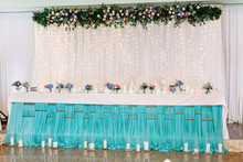 Long Dinner Table Covered With Turquios Cloth And Decorated With