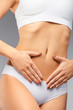 © puhhha - Closeup Of Beautiful Woman With Slim Body Holding Hands On Belly