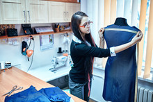 Young Caucasian Female Fashion Designer Taking Measurements On M