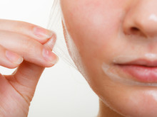 Woman Removing Facial Peel Off Mask Closeup