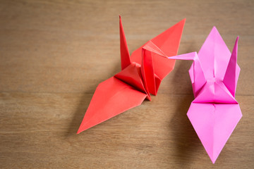 couple paper origami  crane on wooden background close up