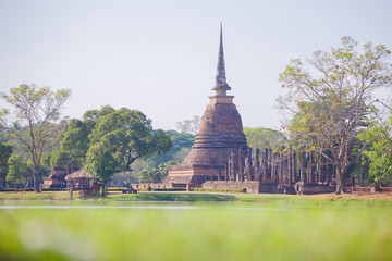 Ancient buddha statue and pagoda at Sukhothai Historical Park, Sukhothai Province, Thailand.