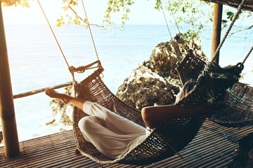 Wall Mural - Woman relaxing in hommack on the beach