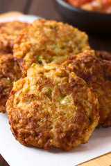 Wall Mural - Rice patties or fritters made of cooked rice, carrot, onion, garlic and celery stalks, photographed with natural light (Selective Focus, Focus on the middle of the first patty)